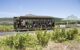 view of the wine tram with passengers travelling on a track between wineries