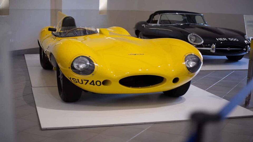 A yellow Jaguar D-Type vintage racing car on display at the Franschhoek motor museum.