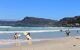 surfers on Muizenberg Beach