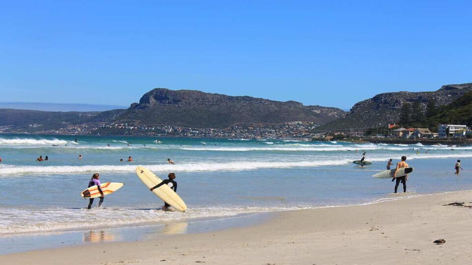 surfers on Muizenberg Beach