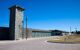 Prison perimeter wall and watchtower on a sunny day