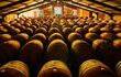 Cellar filled with stacked wine barrels