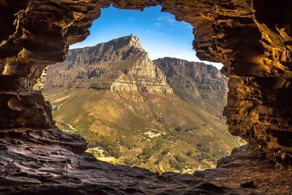 View of the mountain from inside a cave during the daytime