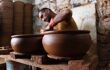 Man working on a kiln in a pottery studio in Avanos, cappadocia