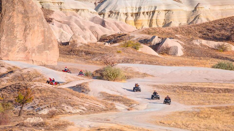 ATV vehicle in wild valley in Cappadocia, Turkey - surrounded among the rocks, dunes and hills in Goreme National Park