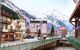 Street view, river, houses, people walking in the center of Chamonix