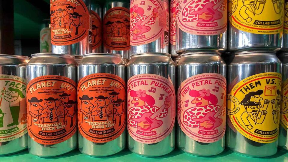 Colorful design of popular danish beer by Mikkeller brewery on many cans of drinks