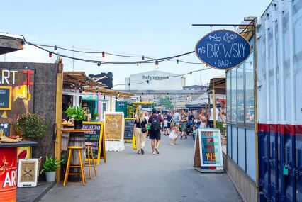 Various beautiful street food cafes. Reffen is a city square and street food market.