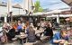 People enjoy a drink by the trendy Torvehallerne indoor food market in the centre of Copenhagen.