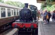 Bodmin Cornwall England Circa May Steam train at the station platform with passengers about to board. Tourist Train. Railway carriage alongside.