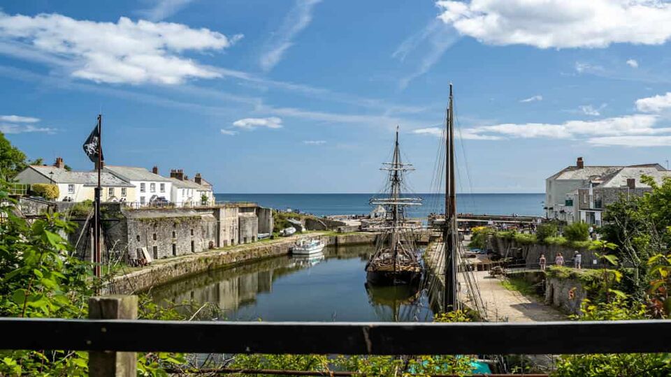 VIew of the port looking at to sea, with sailing ship in dock