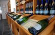 Wide closeup of multiple bottles of award-winning sparkling wines on display at Camel Valley Winery. Travel and Cornish wines.