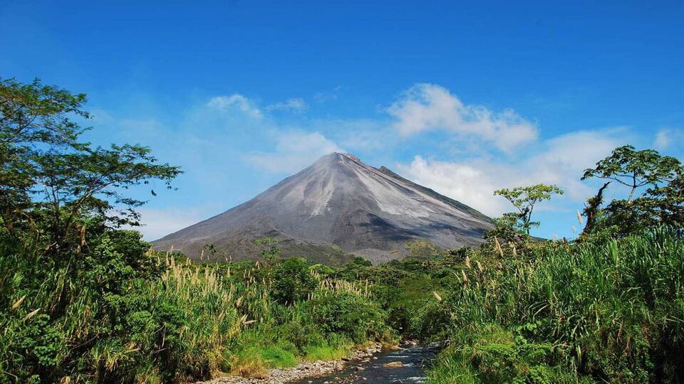 a shot of the volcanoes peak against blue sky