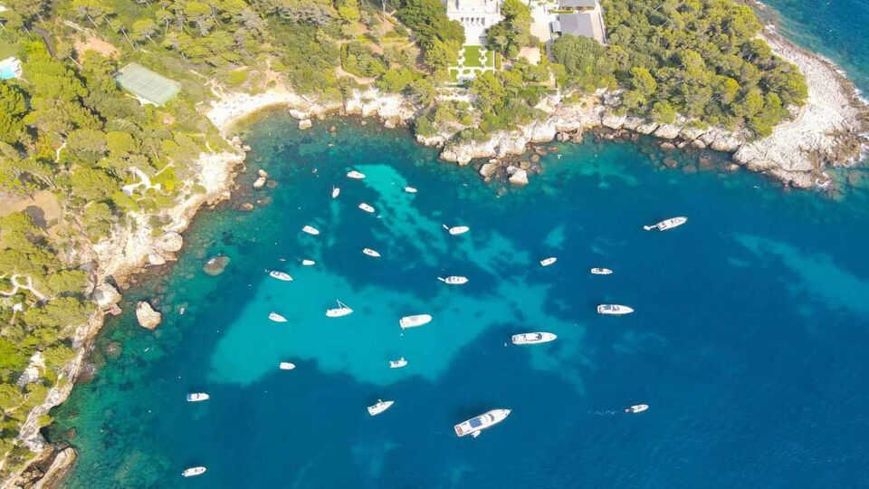 Aerial view of Cap d'Antibes and Billionaire's Bay. Plage de l'argent faux. Beautiful rocky beach near coastal path on the Cap d'Antibes