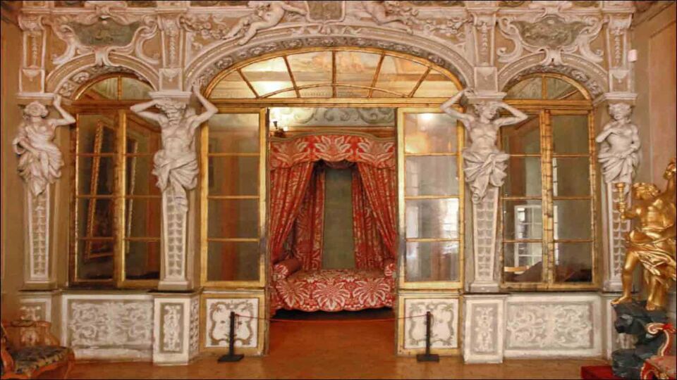 Ornate palace interior with four-poster bed