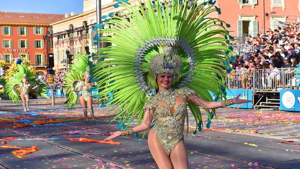 Extravagantly-dressed dancer parades down a street
