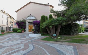 External facade of a small pink coloured church