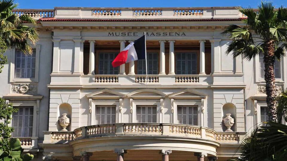 Close up of the exterior of museum with French flag flying