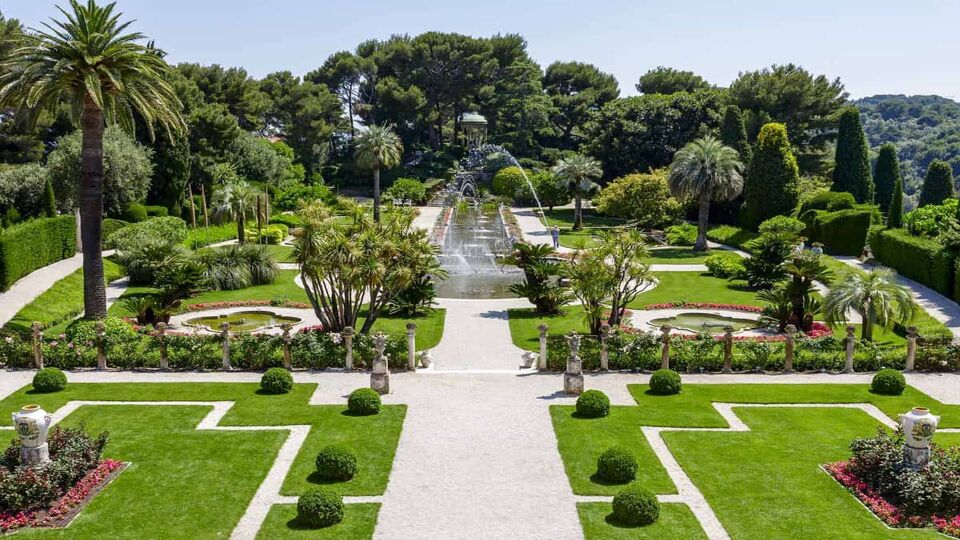 Landscaped formal gardens with walkways and large founatins