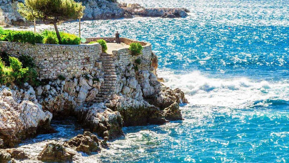 Beautiful scene of a footpath and viewpoint set above dramatic cliffs and blue sea
