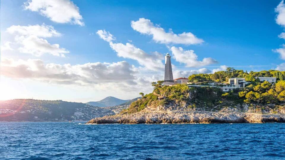 Saint Jean Cap Ferrat lighthouse sitting on cliffs above the path