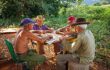 A group of elderly farmers playing dominoes in the country around Vinales, Cuba