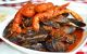 a plate piled high with king prawns and mussels