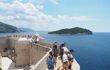 Walking on the Dubrovnik Old Town walls with a view on the bay and the island in front of the city: Lokrum . People are relaxing and enjoying the amazing view