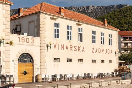 The outside of Stina Winery with its wine cellar in Dalmatia near the Adriatic coast on the island Brac. Mediterranean award winning wines. Facade and mountains