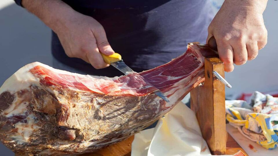 Man slicing famous Dalmatian prosciutto