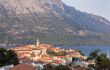 Korcula island with the cathedral, the city and the port on a sunny day during sunset in summer. Beautiful old venetian architecture, trees and mountains creating an idyllic scenery
