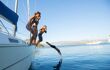 Group of young friends jumping into sea from the sail boat in dalmatian islands