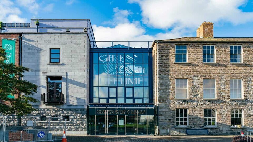 The exterior of the library on a sunny day, with large glass frontage