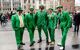 Group of five men in green suits on the streets of Dublin on St Patrick's Day