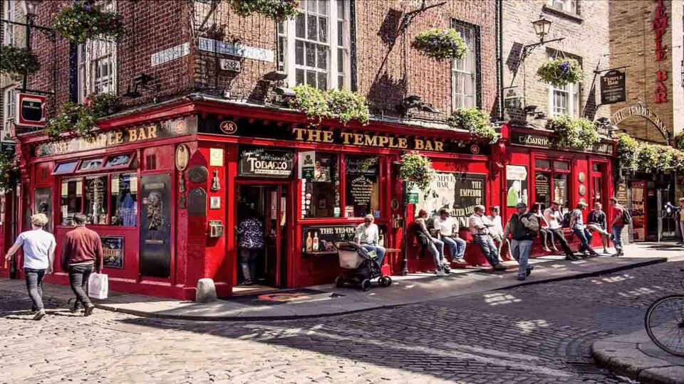 People relax and drink outside the famous Irish pub The Temple Bar