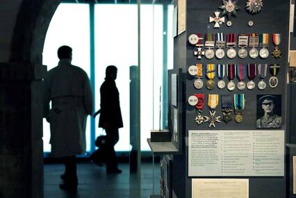A photograph displaying medals awarded to Sean Bell in the National War Museum at Edinburgh with museum goes in the background