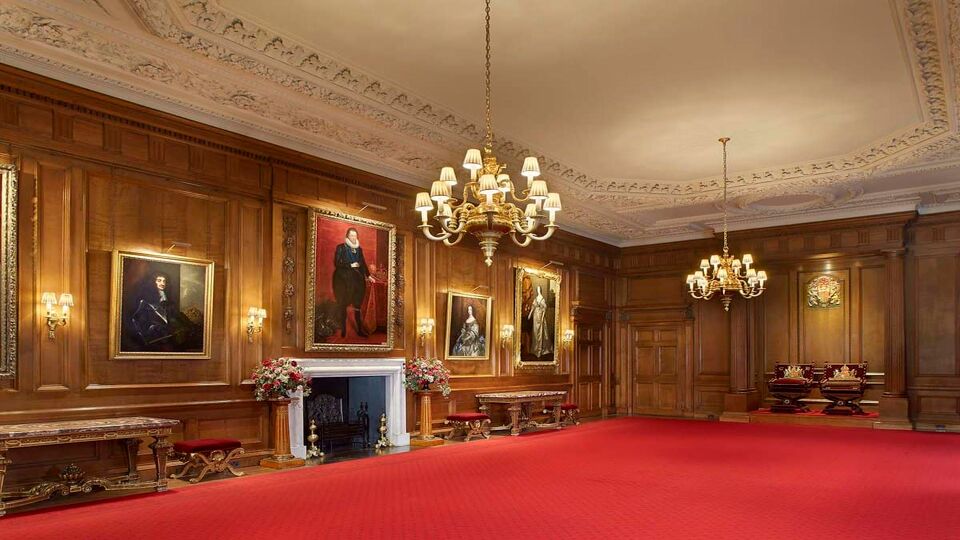 Empty room with red carpet and wooden panelling