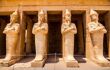 Ancient statues outside pharaoh Queen Hatshepsut's temple, located on the west bank of the Nile River near the Valley of the Kings and city of Luxor