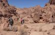Local bedouin and hikers on the hiking trail in the Southern Sinai. Panoramic view over the trail on surrounding mountains and valleys.