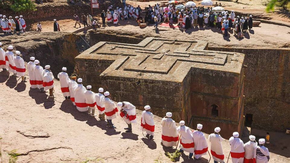 local priests standing around the top of the church conducting a ceremony