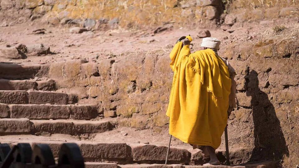 local man climbing steps to Church of St. George, Lalibela