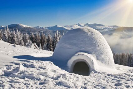 an igloo in a field of snow in Lapland
