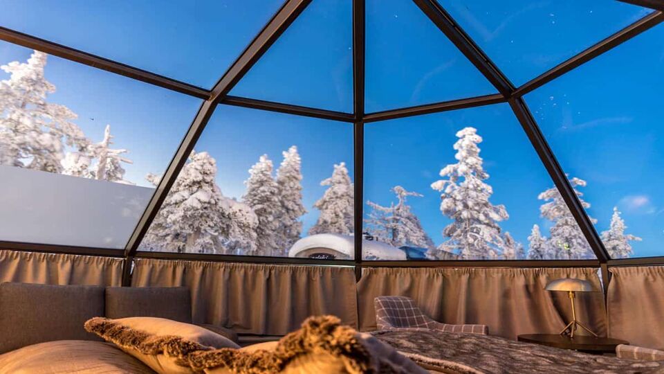 Inside an igloo looking out from bed during daylight