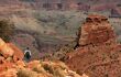 Small figure on a hiking trail surrounded by towering grand canyon scenery