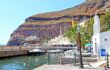 A view of the old port at Fira with small boats, dinghies and tour boats.
