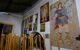 A worshiper lights a candle in the Holy Monastery of Archangel Michael Panormitis in Symi Dodecanese, Greece