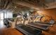 Row of treadmills and weights in a mirrored gym