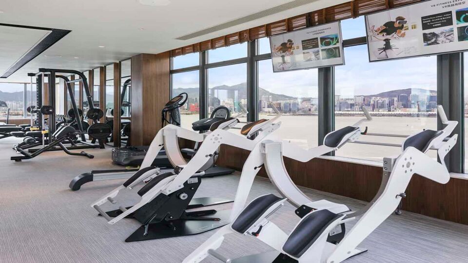 Interior of the hotel gym overlooking the bay