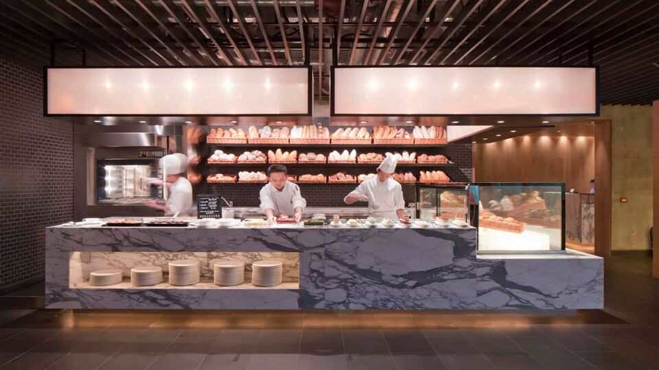 Chefs freshly prepare food behind a counter