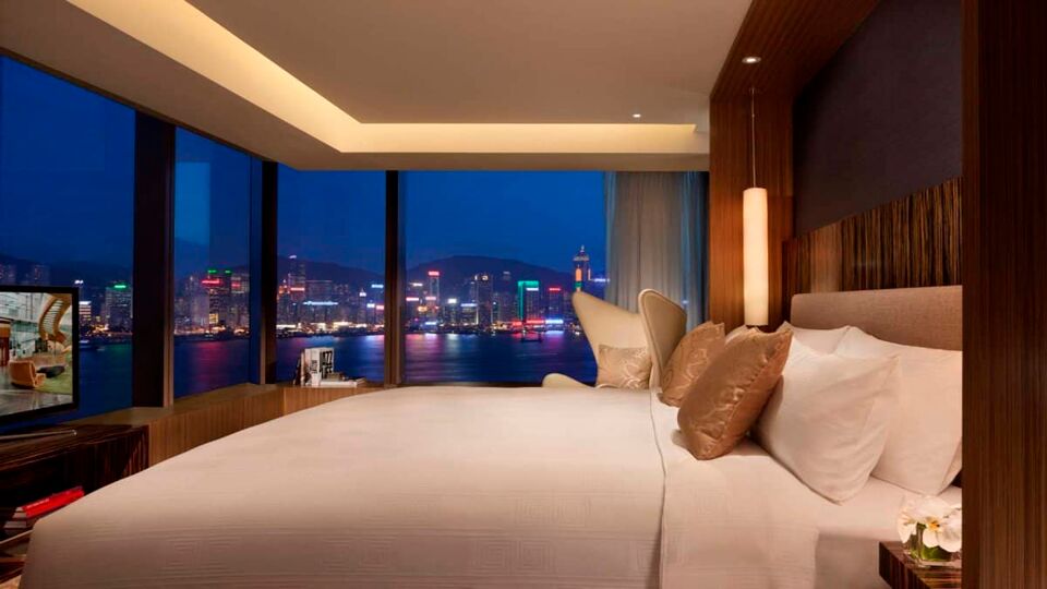 Bedroom with a view of the city at night